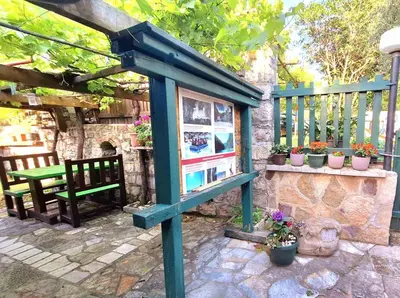 a blue stand with a bench and some plants at Eko apartments Drvljanik in Kaluđerac