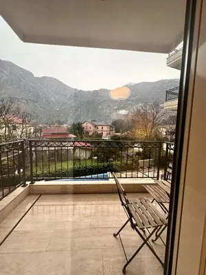 a chair sitting on a balcony with a view at Posto Capitano apartment Sasa in Kotor