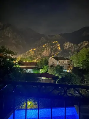 a view of a mountain at night with lights at Posto Capitano apartment Sasa in Kotor