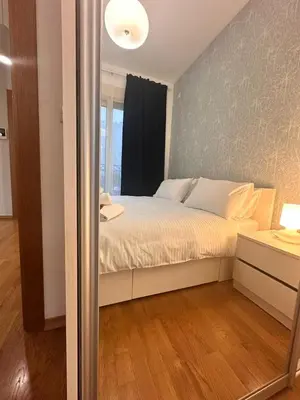 a bedroom with a bed with a window and a mirror at Posto Capitano apartment Sasa in Kotor