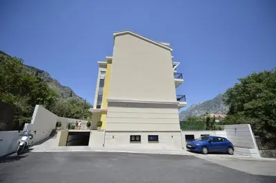 a car parked in a parking lot in front of a building at Posto Capitano apartment Sasa in Kotor