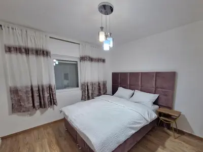 a bedroom with a large bed and a window at Podgorica Near Big Fashion in Podgorica