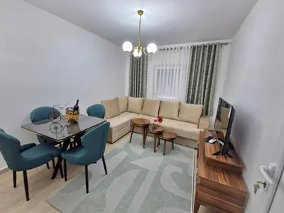 a living room with a couch and a table at Podgorica Near Big Fashion in Podgorica