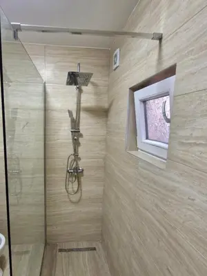a shower with a glass door in a bathroom at Podgorica Near Big Fashion in Podgorica