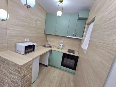 a kitchen with a counter with a microwave and a sink at Podgorica Near Big Fashion in Podgorica