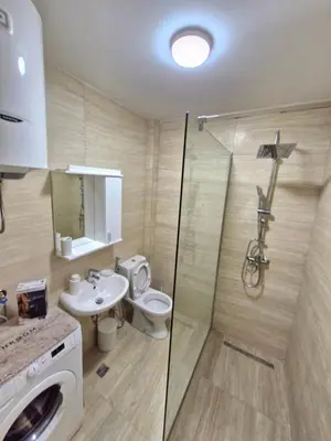 a bathroom with a toilet and a sink and a shower at Podgorica Near Big Fashion in Podgorica