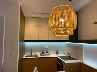 a kitchen with a sink and a pendant light at Cozy one bedroom apartment in Podgorica