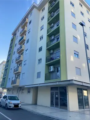 a building with a car parked in front of it at Cozy one bedroom apartment in Podgorica