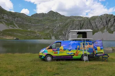 a van with a camper on the side of a lake at Escape Montenegro Campervan Tranzit in Podgorica