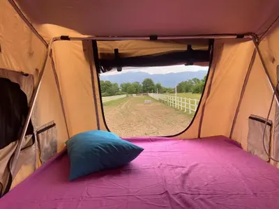 a tent with a pillow sitting inside of it at Escape Montenegro Campervan Tranzit in Podgorica