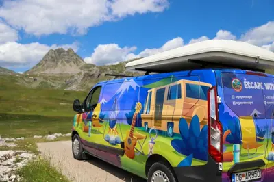 a colorful van parked on a dirt road with a mountain at Escape Montenegro Campervan Tranzit in Podgorica