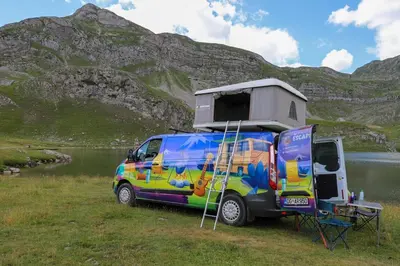a van parked in a field with a camper on it at Escape Montenegro Campervan Tranzit in Podgorica