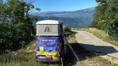 a small vehicle parked on the side of a road at Escape Montenegro Campervan Tranzit in Podgorica