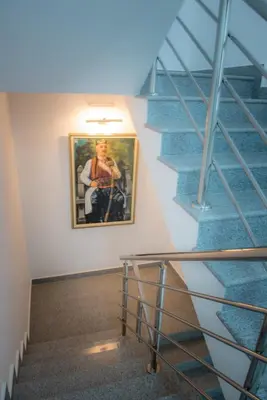 a picture of a man on a painting on a wall at Apartmani Barović Bečići in Becici