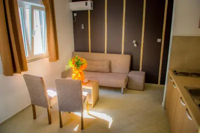 a small living room with a table and a couch at Apartmani Barović Bečići in Becici