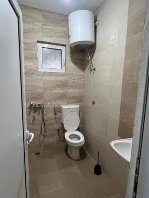 a small bathroom with a toilet and a sink at Apartments Bettii in Ulcinj