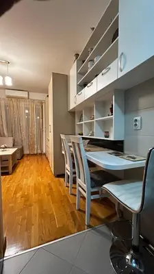 a kitchen and dining room with a table and chairs at Sunrise apartment in Podgorica
