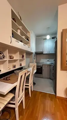 a kitchen with a table and chairs in a room at Sunrise apartment in Podgorica