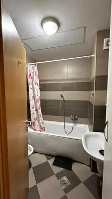 a bathroom with a bath tub and a sink at Sunrise apartment in Podgorica