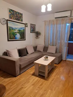 a living room with a couch and a table at Sunrise apartment in Podgorica