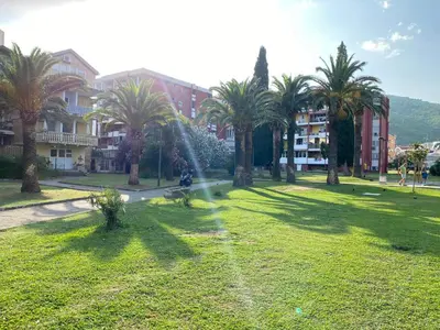 a person is playing with a fountain in a park at Kali in Budva