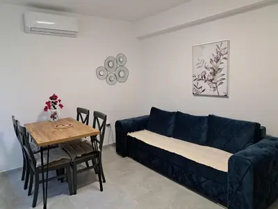 a living room with a blue couch and a table at Kali in Budva