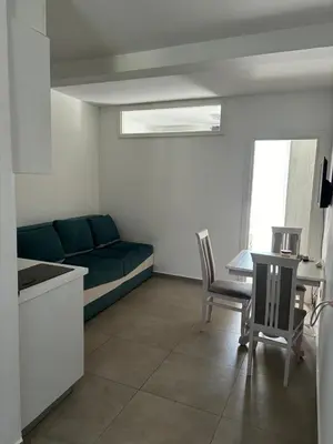 a living room with a couch and a table at Aleksandar in Budva