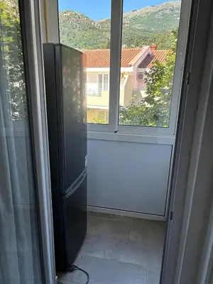 a door to a window with a view of a house at Aleksandar in Budva