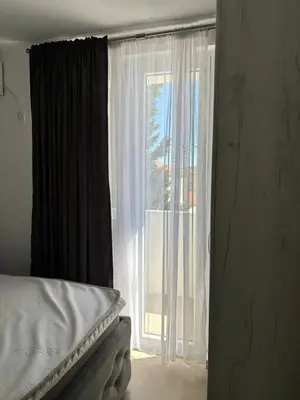 a bedroom with a bed and a large window at Aleksandar in Budva
