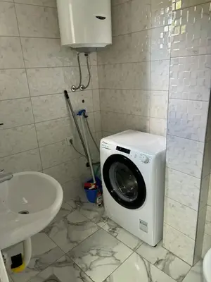 a washing machine in a bathroom with a sink at Aleksandar in Budva