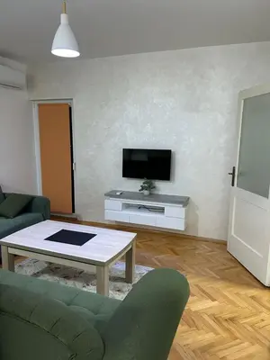 a living room with a couch and a tv at Apartman Autobuska in Podgorica
