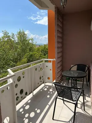 a balcony with two chairs and a table on it at Apartman Autobuska in Podgorica