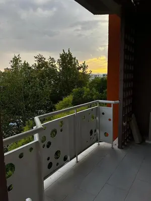 a white railing on a balcony with a view at Apartman Autobuska in Podgorica