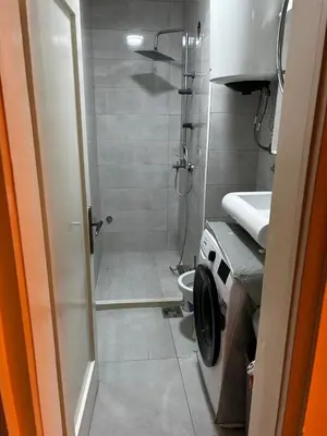 a bathroom with a shower and a toilet and a sink at Apartman Autobuska in Podgorica