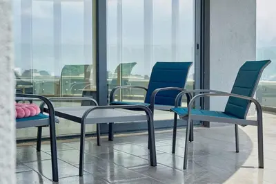 a group of chairs and a table in a room at Панорамная квартира на первой линии моря Skyline Resort, Becici, Budva in Becici