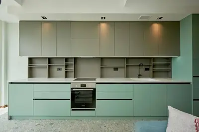 a kitchen with white cabinets and an oven at Панорамная квартира на первой линии моря Skyline Resort, Becici, Budva in Becici