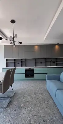 a living room with a couch and a ceiling fan at Панорамная квартира на первой линии моря Skyline Resort, Becici, Budva in Becici