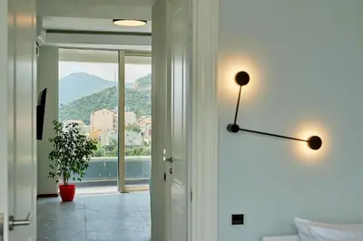 a room with a door with a view of a mountain at Панорамная квартира на первой линии моря Skyline Resort, Becici, Budva in Becici