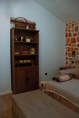 a bedroom with a book shelf and a bed at Etno House Mali Grm in Bar