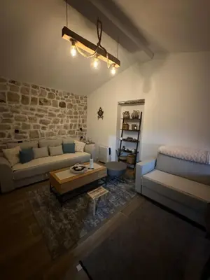 a living room with a couch and a table at Etno House Mali Grm in Bar