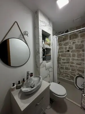 a bathroom with a toilet and a sink and a mirror at Etno House Mali Grm in Bar