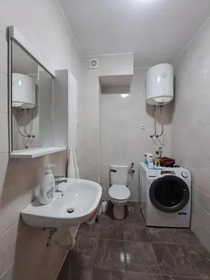 a bathroom with a sink and a washing machine at Gruda 086 in Cetinje