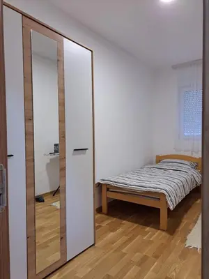 a bedroom with a mirror and a bed in it at Gruda 086 in Cetinje