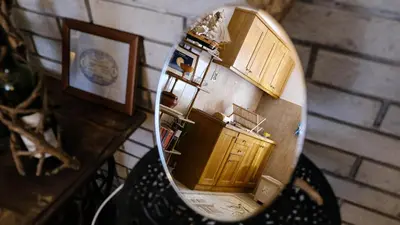 a reflection of a kitchen in a mirror at Country House Djurisic in Virpazar