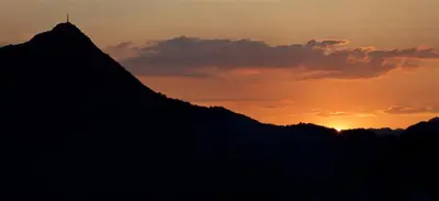 a silhouette of a mountain at sunset at Country House Djurisic in Virpazar