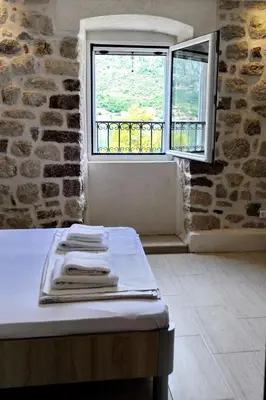a room with a table and a window at Apartments Ave R in Kotor