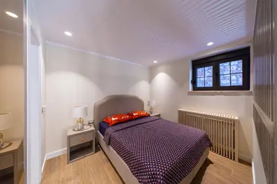 a bedroom with a bed with red pillows on it at Villa Seaside Shore in Budva