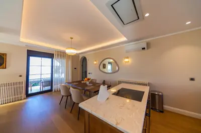 a living room with a table and a dining room at Villa Seaside Shore in Budva