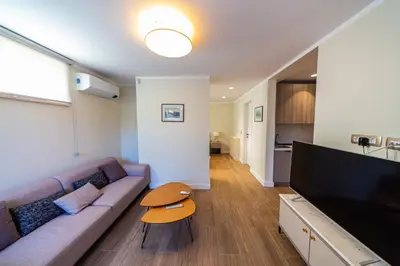a living room with a couch and a flat screen tv at Villa Seaside Shore in Budva