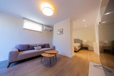 a living room with a couch and a table and a bed at Villa Seaside Shore in Budva